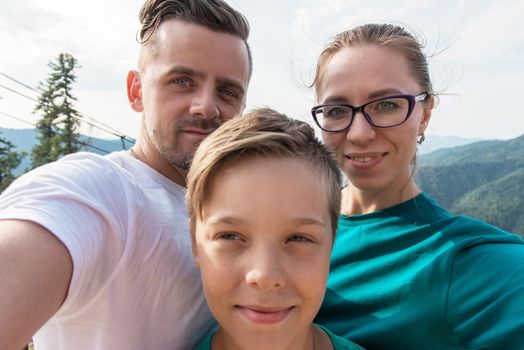 Selfie of family on the Teletskoye lake in Altai mountains, Siberia, Russia. Beauty summer day.