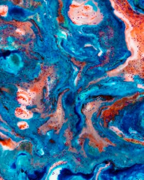 Vertically acrylic blue background with red lines and sparkles. Colorful marble texture. Fluid liquid marble. Art picture. Avant-garde creativity.