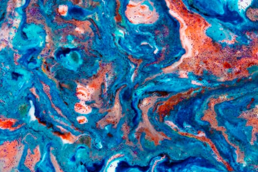 The background is acrylic blue with red lines and sparkles. Colorful marble texture. Fluid liquid marble. Art picture. Avant-garde creativity.