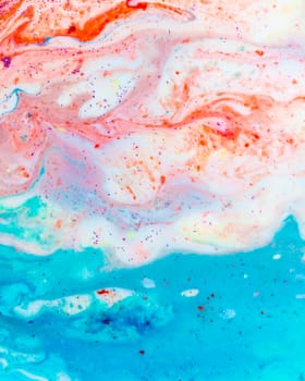 The background is acrylic soft blue with pink and sparkles. Colorful marble texture. Fluid liquid marble. Art picture. Avant-garde creativity.