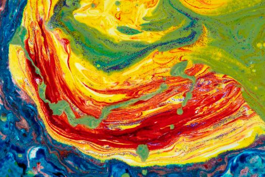 Multicolored marble acrylic background. A smudged spot of various paints covered with sequins. Colorful avant-garde texture.