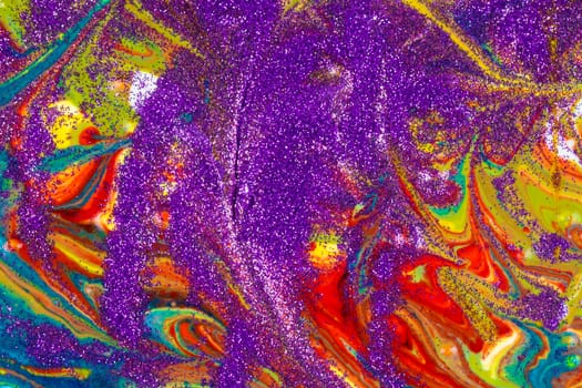 Multicolored acrylic backdrop sprinkled with purple sequins. Contemporary creativity. Colorful avant-garde texture. A background made up of many textures, shapes and materials.