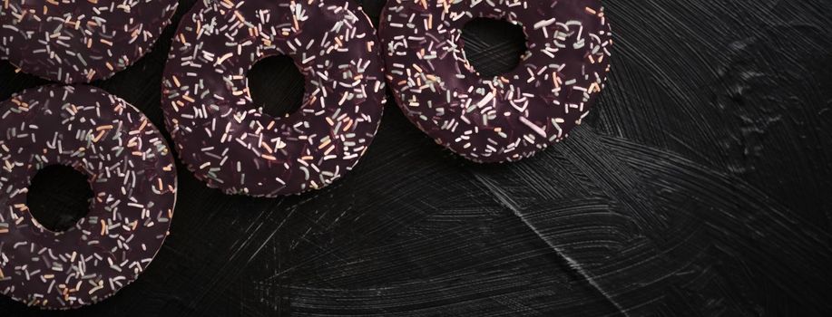 Bakery, branding and cafe concept - Frosted sprinkled donuts, sweet pastry dessert on rustic wooden background, doughnuts as tasty snack, top view food brand flat lay for blog, menu or cookbook design