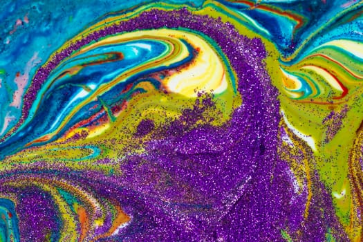 Multicolored acrylic backdrop sprinkled with purple sparkles. Contemporary creativity. Colorful avant-garde rich texture. A background made up of many shapes and materials.