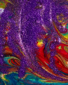 Multicolored acrylic backdrop sprinkled with purple sparkles. Contemporary creativity. Colorful avant-garde rich texture. A background made up of many shapes and materials.