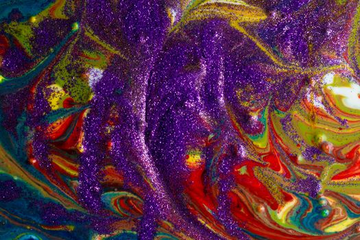 Multicolored acrylic backdrop sprinkled with purple sparkles. Contemporary creativity. Colorful avant-garde rich texture. A background made up of many shapes and materials.