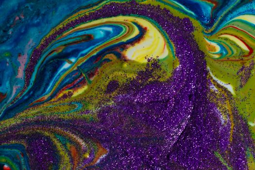 Multicolored acrylic backdrop sprinkled with purple sparkles. Contemporary creativity. Colorful avant-garde rich texture. A background made up of many shapes and materials.