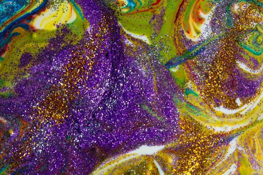 Multicolored acrylic backdrop sprinkled with purple sparkles. Contemporary creativity. Colorful avant-garde rich texture. A background made up of many shapes and materials.