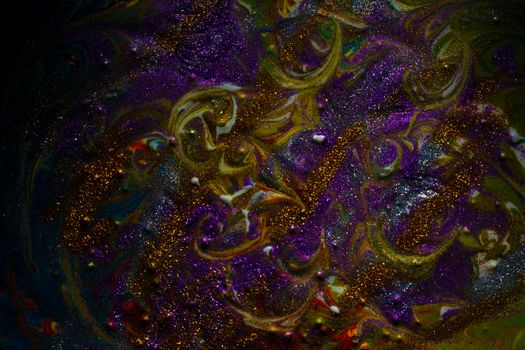 Multi-colored dark background sprinkled with purple and gold sparkles. Contemporary creativity. A colorful avant-garde painting with rich texture. A background made up of many shapes and materials.