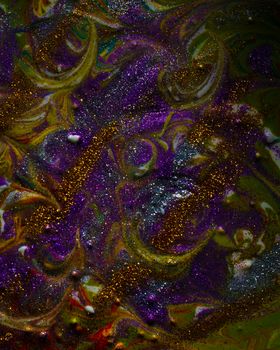 Multi-colored dark background sprinkled with purple and gold sparkles. Contemporary creativity. A colorful avant-garde painting with rich texture. A background made up of many shapes and materials.