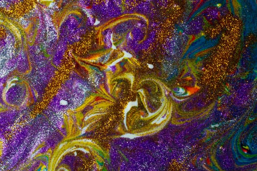 Multicolored acrylic background with curls sprinkled with purple and gold sparkles. Contemporary creativity. A colorful avant-garde painting with rich texture. A background made up of many shapes and materials.