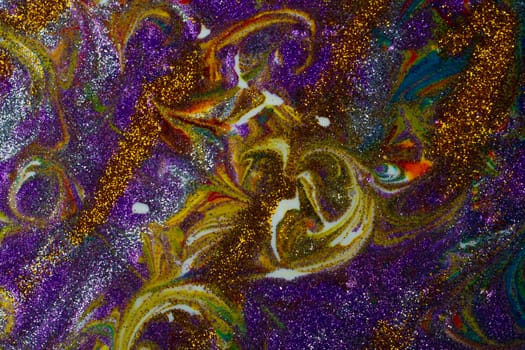 Multicolored acrylic background with curls sprinkled with purple and gold sparkles. Contemporary creativity. A colorful avant-garde painting with rich texture. A background made up of many shapes and materials.