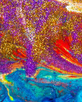 Multicolored vertical acrylic backdrop sprinkled with purple and gold sparkles. Contemporary creativity. A colorful avant-garde painting with rich texture. A background made up of many shapes and materials.