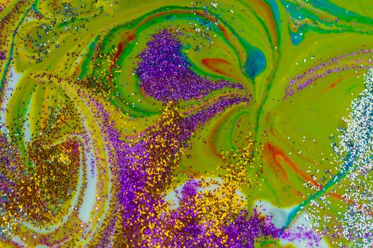 Multicolored acrylic background with curls sprinkled with purple and gold sparkles. Contemporary creativity. A colorful avant-garde painting with rich texture. A background made up of many shapes and materials.