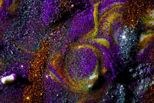 Multi-colored dark background sprinkled with purple and gold sparkles with streaks and waves. Contemporary creativity. A colorful avant-garde painting with rich texture. A background made up of many shapes and materials.
