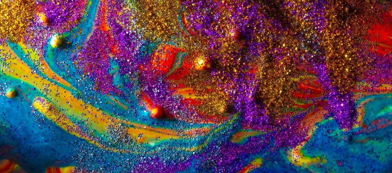 Multicolored acrylic background with curls sprinkled with purple and gold sparkles. Contemporary creativity. A colorful avant-garde painting with rich texture. A background made up of many shapes and materials.