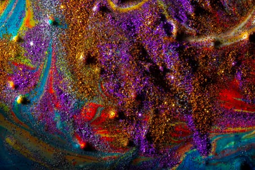 Multicolored acrylic background with curls sprinkled with purple and gold sparkles. Contemporary creativity. A colorful avant-garde painting with rich texture. A background made up of many shapes and materials.