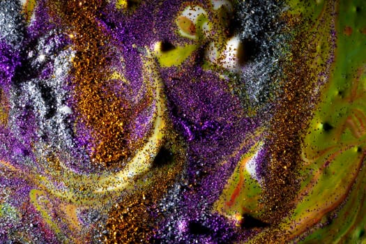 Multi-colored dark background sprinkled with purple and gold sparkles with streaks and waves. Contemporary creativity. A colorful avant-garde painting with rich texture. A background made up of many shapes and materials.
