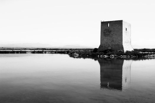Beautiful Tamarit tower surrounded by salt lagoons in Santa Pola, Alicante, Spain