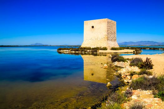 Beautiful Tamarit tower surrounded by salt lagoons in Santa Pola, Alicante, Spain