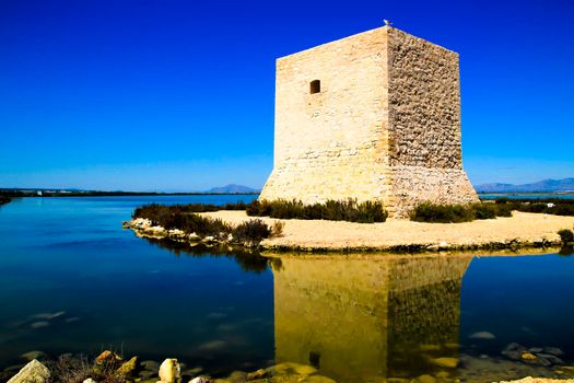 Beautiful Tamarit tower surrounded by salt lagoons in Santa Pola, Alicante, Spain