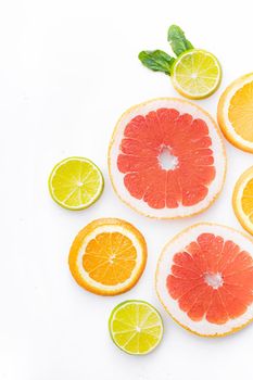 Citrus fruits on a white background are cut . Colored fruits. The citrus family. citrus sliced layout top view on a white background. An article about healthy eating. Keto diet. Fruit food.