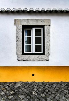Old colorful and bright typical facade in Lisbon with beautiful vintage wooden window