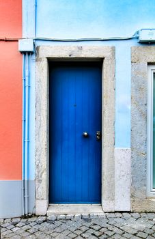Old and colorful wooden door with iron details in Lisbon, Portugal