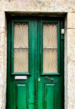 Old and colorful wooden door with iron details in Lisbon, Portugal