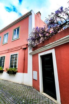Old colorful and beautiful facades with vintage streetlight in Lisbon streets in Spring.