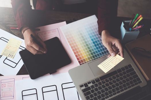 Until creating a mobile application, a developer compares color and interface wireframes.