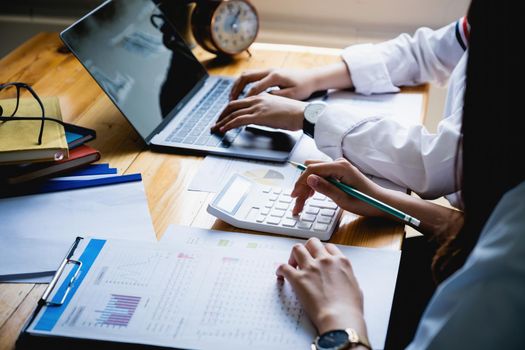 For the investigation of a corruption account, a group of businesswomen and accountants search data documents on a laptop. definition of anti-bribery.
