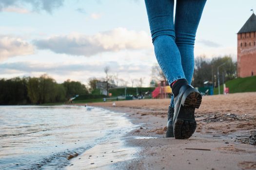 Woman walk on the beach. Rest in the city.