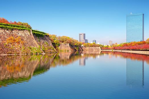 autumn scenery and modern buildings around moat river of osaka castle osaka japan