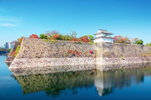 autumn scenery and modern buildings around moat river of osaka castle osaka japan