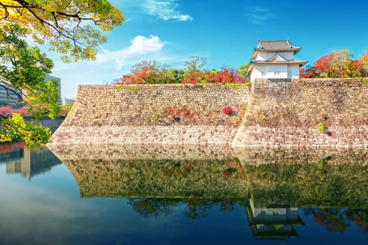 Osaka Castle in osaka city with autumn leaves. Japan