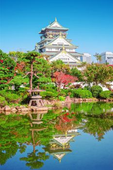 autumn scenery and modern buildings around moat river of osaka castle osaka japan