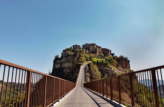 View of Civita di Bagnoregio , old town in central Italy situated in the valley of the badlands founded by Etruscans , it's known as La città che muore -the dying town -