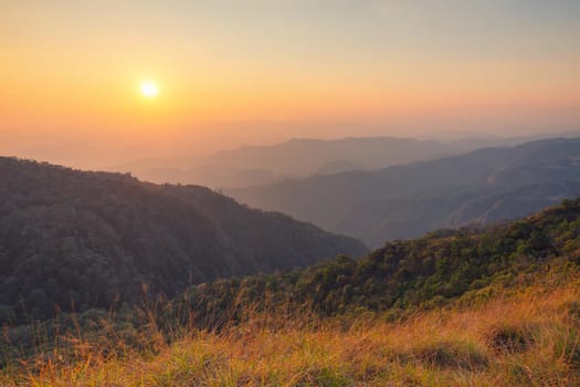 Colorful sunset in the mountains landscape. Dramatic overcast sky.