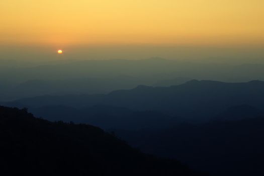 Colorful sunset in the mountains landscape. Dramatic overcast sky.