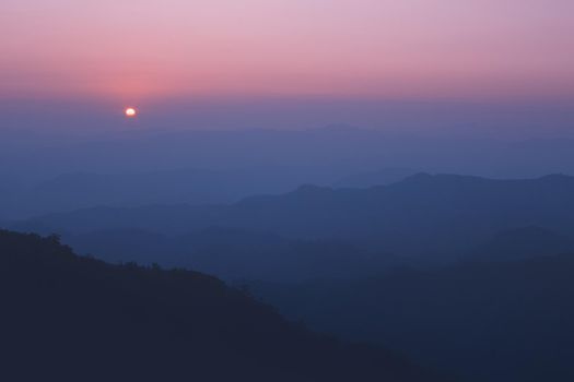 Colorful sunset in the mountains landscape. Dramatic overcast sky.