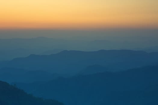 Colorful sunset in the mountains landscape. Dramatic overcast sky.