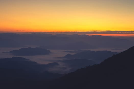 Landscape of mountain view with morning fog at sunrise time.