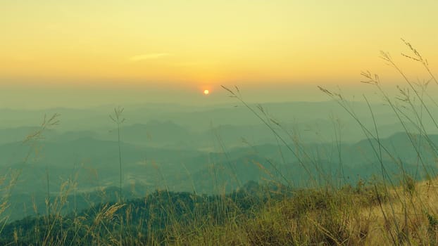 Colorful sunset in the mountains landscape. Dramatic overcast sky.