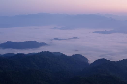 Landscape of mountain view with morning fog at sunrise time.