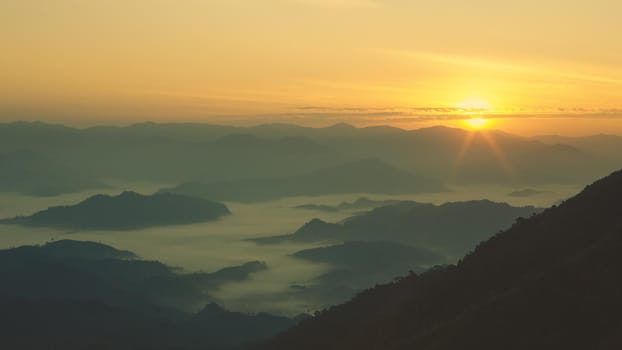 Colorful sunset in the mountains landscape. Dramatic overcast sky.