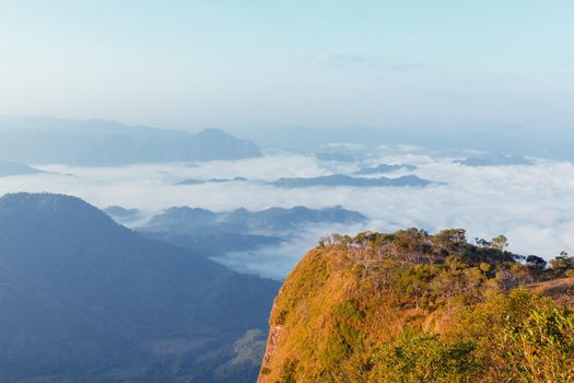 Landscape of mountain view with morning fog at sunrise time.
