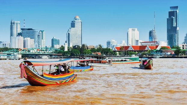 Long-tail boats in Chao Phraya river in Bangkok, Thailand. Image with selective focus