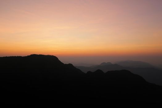 Colorful sunset in the mountains landscape. Dramatic overcast sky.