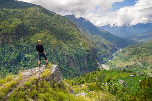 Man standing on top of the hill in Himalayas. Achievement and success. Trekking in Nepal